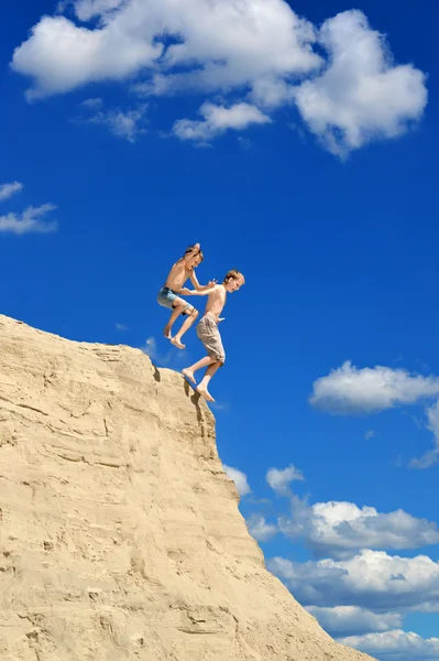 Chicos saltando de una colina — Foto de Stock