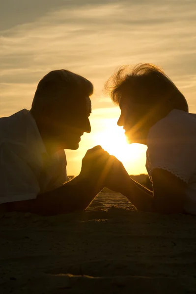 Elderly couple at sunset — Stock Photo, Image