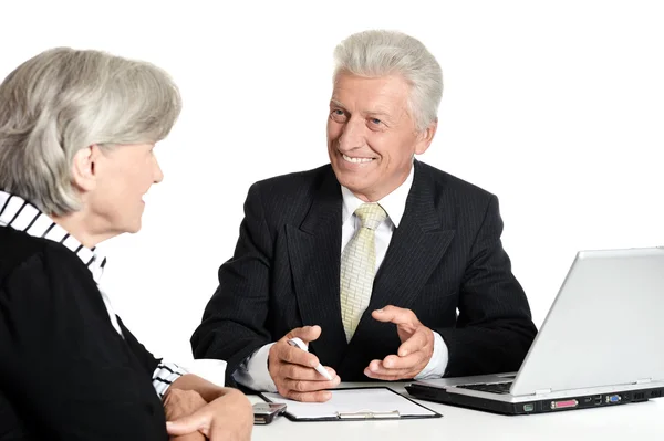 Elderly businessman speaking to a woman — Stock Photo, Image