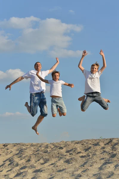 Happy family jumping outdoors — Stock Photo, Image