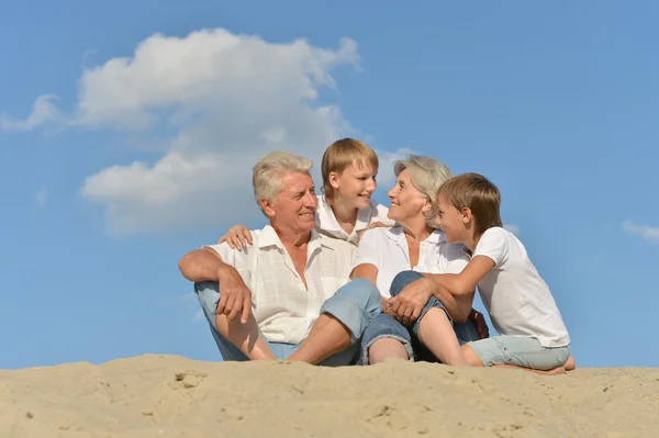 Big happy family relaxing on the sand together — Stock Photo, Image