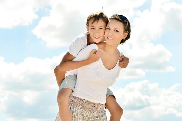 Happy mother and son on a background of a sky — Stock Photo, Image