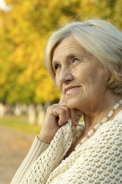 Happy old woman in autumn — Stock Photo, Image