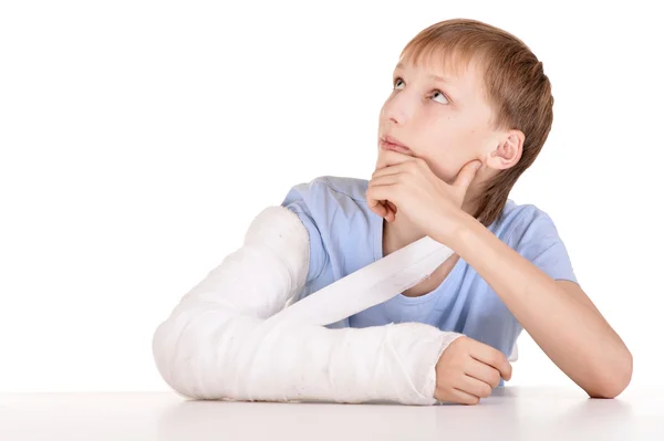 Portrait of boy with a broken arm on white background — Stock Photo, Image