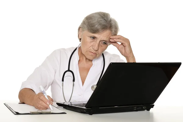Médico maduro com um laptop em um fundo branco — Fotografia de Stock