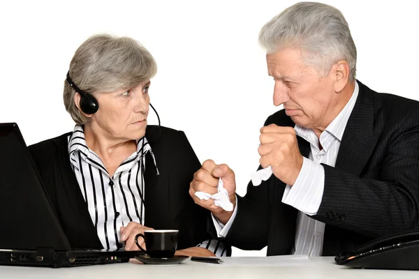 Mature couple in the workplace on a white background — Stock Photo, Image