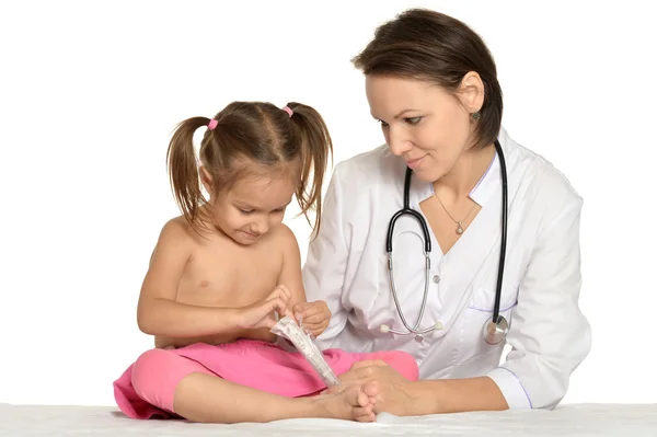 Little girl visiting the doctor pediatrician Stock Image