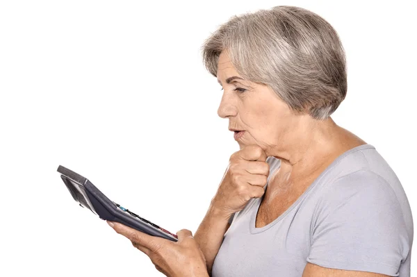 Serious elderly woman with calculator — Stock Photo, Image