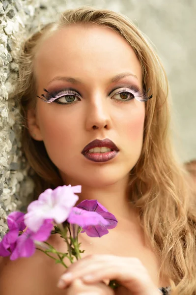 Girl with flower and artistic makeup — Stock Photo, Image