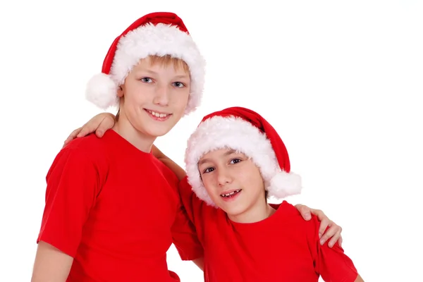 Irmãos pequenos em chapéus de santa — Fotografia de Stock