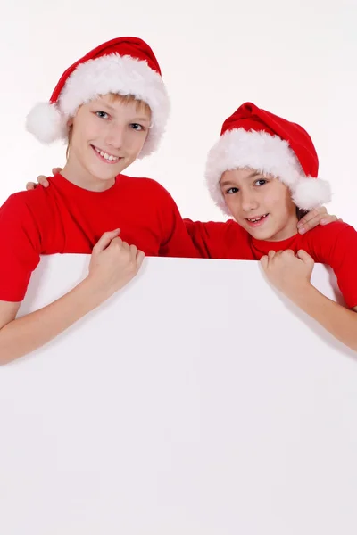 Santa kids with board — Stock Photo, Image