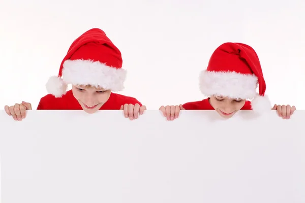 Santa kids with board — Stock Photo, Image