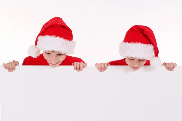 Santa niños con tabla —  Fotos de Stock