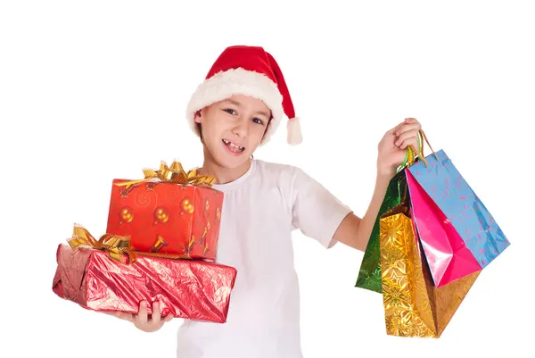 Kid i santa mössa med gåvor — Stockfoto