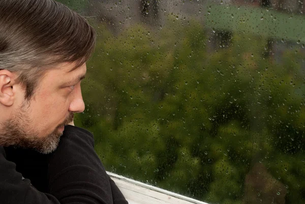 Homem adorável na frente da janela — Fotografia de Stock