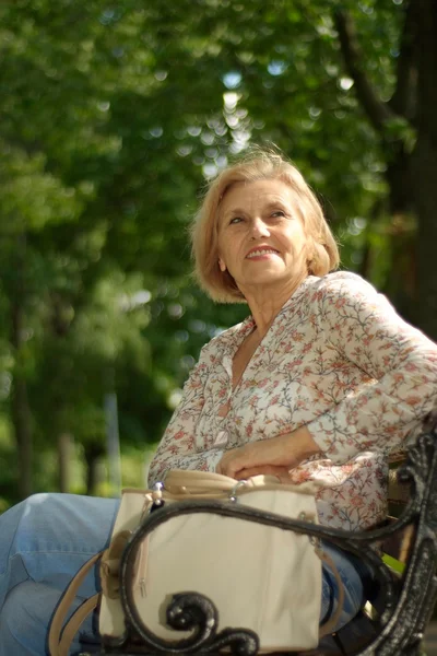 Aantrekkelijke oudere vrouw rust in de natuur — Stockfoto