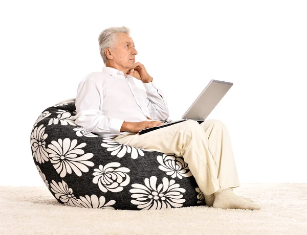 Thoughtful elderly man with laptop — Stock Photo, Image