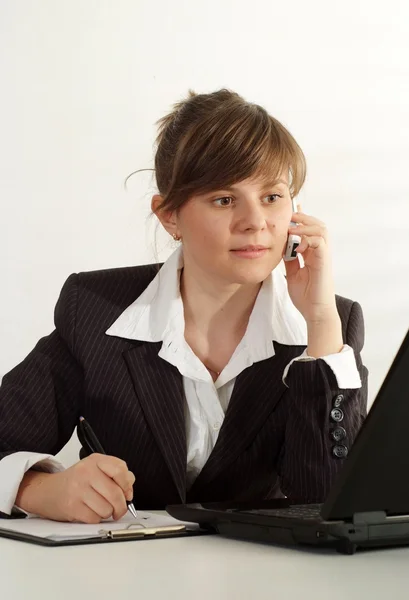 Talking brunette in her office — Stock Photo, Image