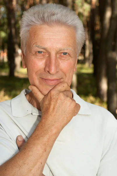 Happy elderly man in the forest — Stock Photo, Image