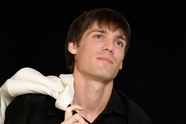 Nice man in a black shirt on a dark — Stock Photo, Image