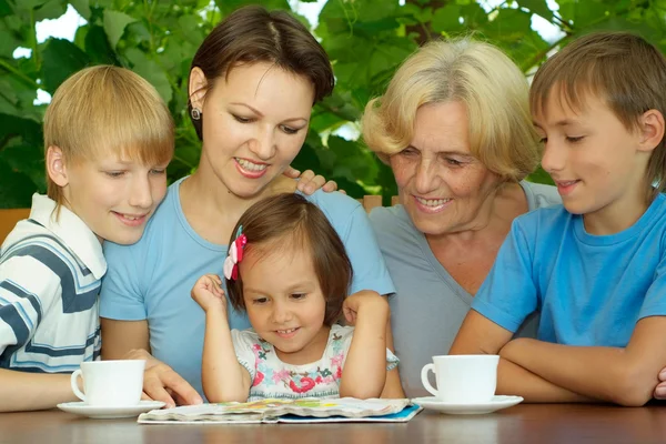 Beauteous family sitting on the veranda — Stock Photo, Image