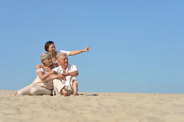 Люди, що сидять на піску — стокове фото