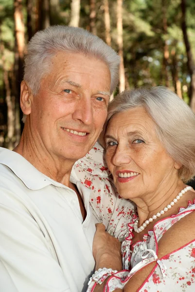 Pretty elderly couple in the forest — Stock Photo, Image