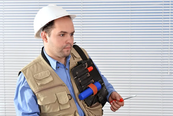 Confident handyman in studio — Stock Photo, Image