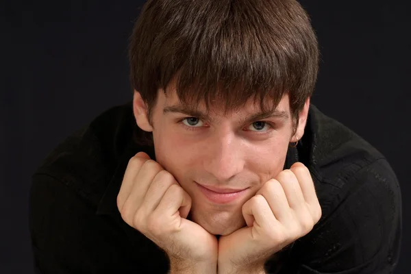 Handsome young man on a dark — Stock Photo, Image