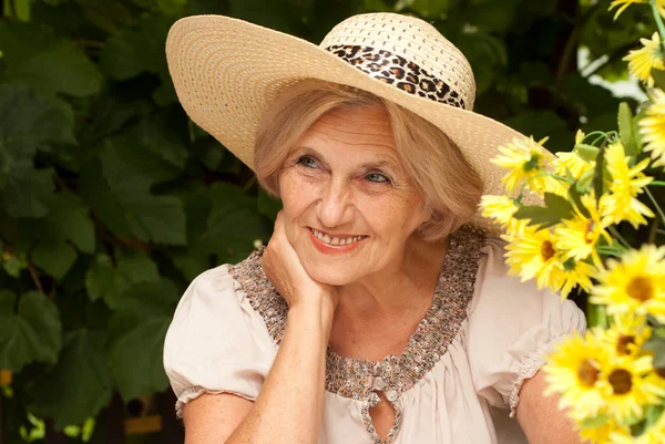Beauteous older woman sitting on the veranda — Stock Photo, Image
