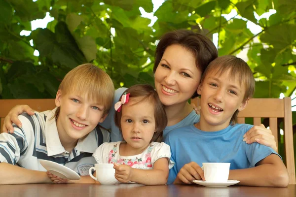 Happy family sitting on the veranda — Stock Photo, Image