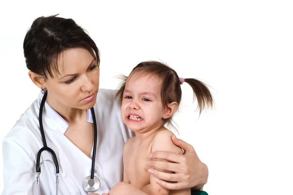 Doctor with a crying girl Royalty Free Stock Images