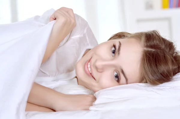 Girl lying in bed — Stock Photo, Image