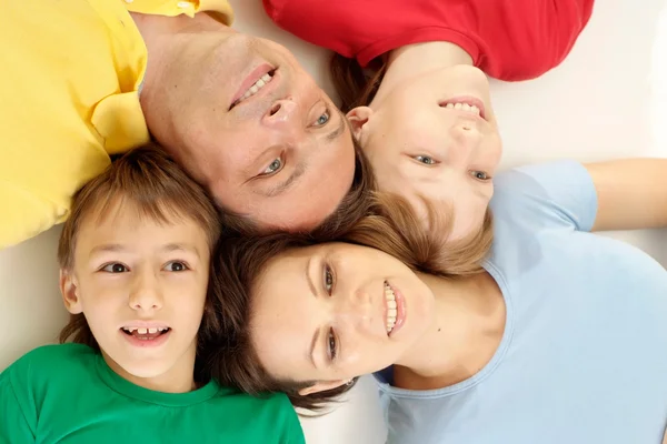 Glad family in bright T-shirts — Stock Photo, Image