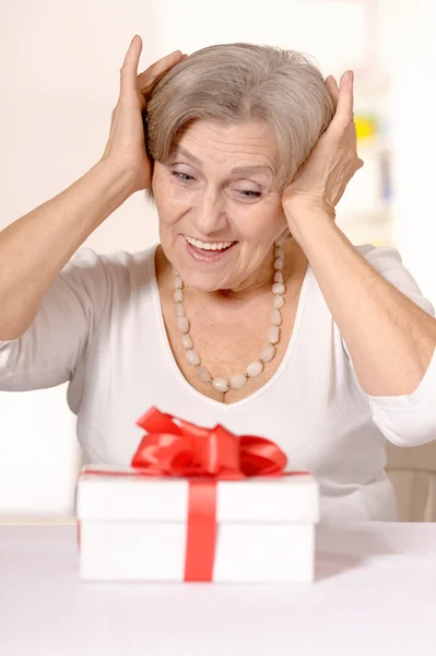 Elderly woman with gift — Stock Photo, Image