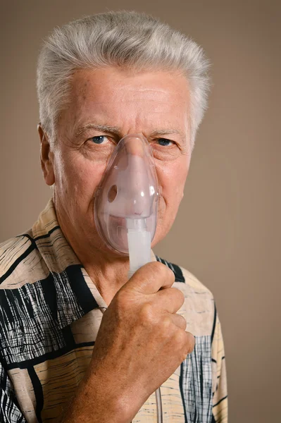 Elder man making inhalation — Stock Photo, Image