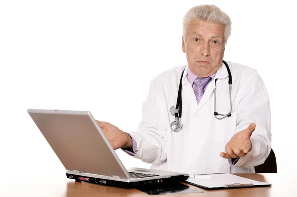 Happy Caucasian doctor with a laptop sitting — Stock Photo, Image