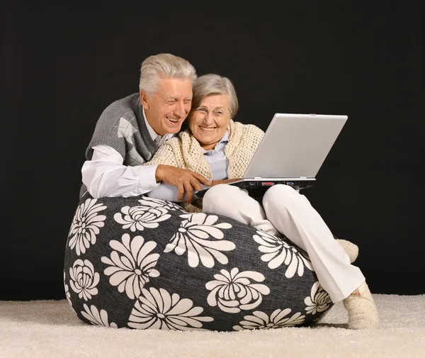 Elderly couple with nitebook — Stock Photo, Image