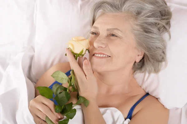 Beautiful older woman resting in the bedroom