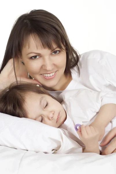 Een mooie goede Kaukasische moeder met haar dochter liegen — Stockfoto