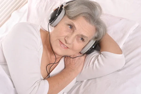 Senior senhora em fones de ouvido — Fotografia de Stock