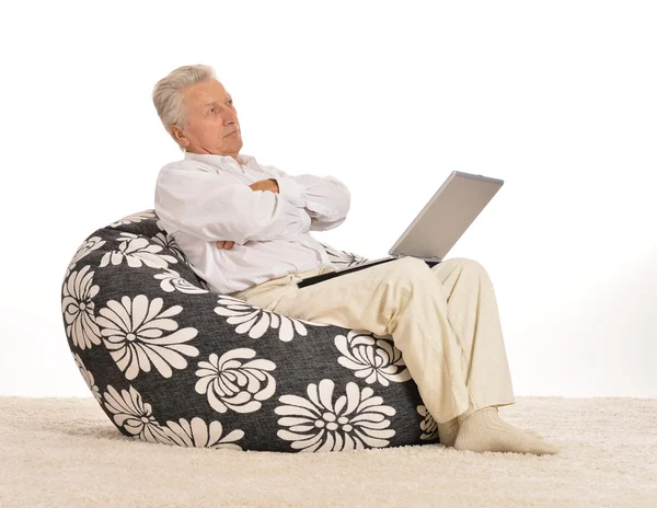 Thoughtful elderly man with laptop — Stock Photo, Image