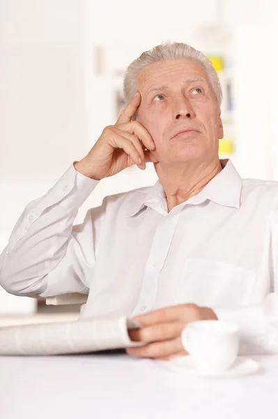 Senior man with newspaper — Stock Photo, Image