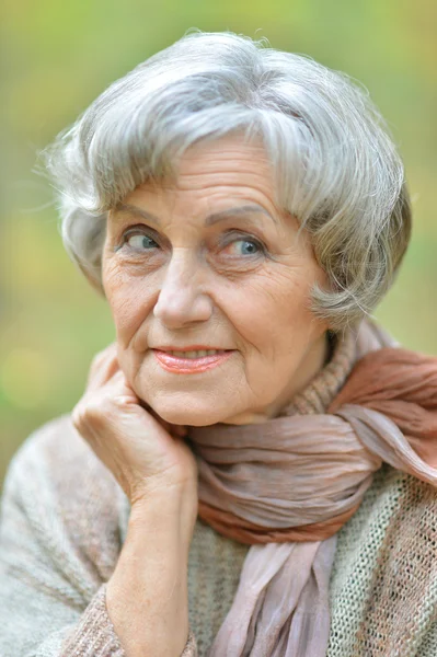 Thoughtful senior woman in autumn — Stock Photo, Image