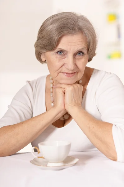 Elderly woman is resting at home — Stock Photo, Image
