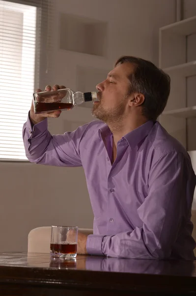 Мужчина пьет виски — стоковое фото