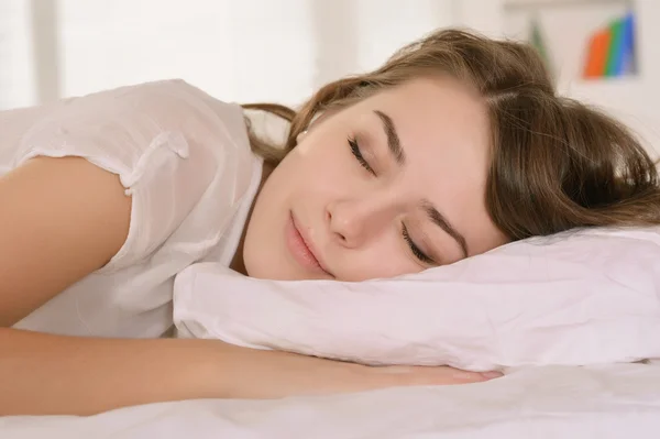 Girl lying in bed — Stock Photo, Image