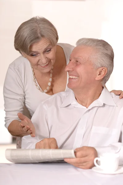 Cute old couple reading newspaper — Stock Photo, Image