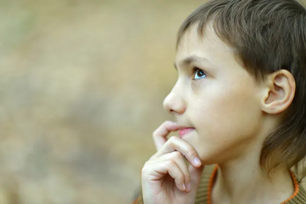 Portrait of thinking young boy in autumn park — Stock Photo, Image