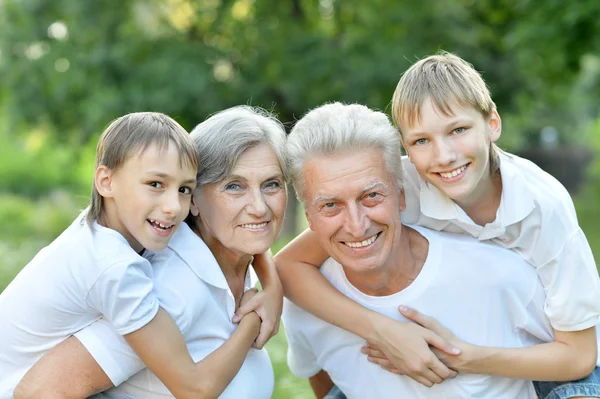 Ältere Männer und Frauen mit ihren Enkeln — Stockfoto